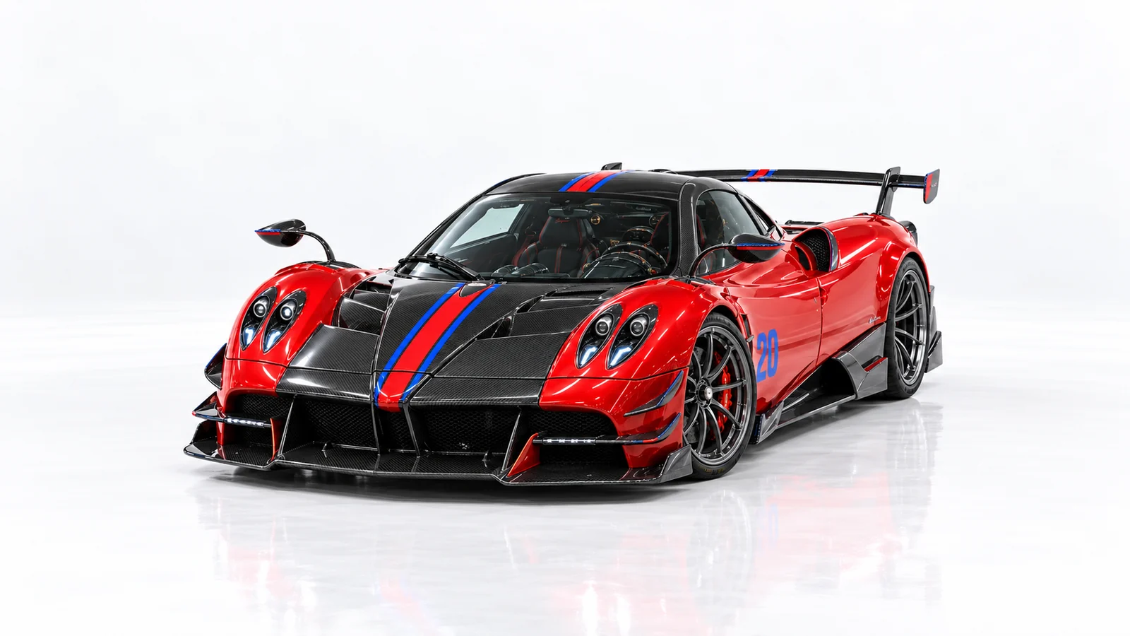 Red Huayra BC seen from the front left, with blue racing stripes and a carbon splitter