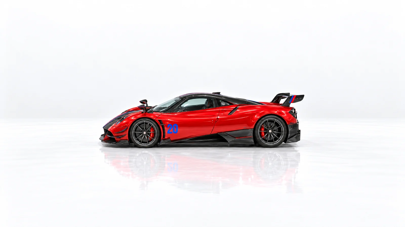 Left side profile of the red Huayra BC with gunmetal wheels and rear wing