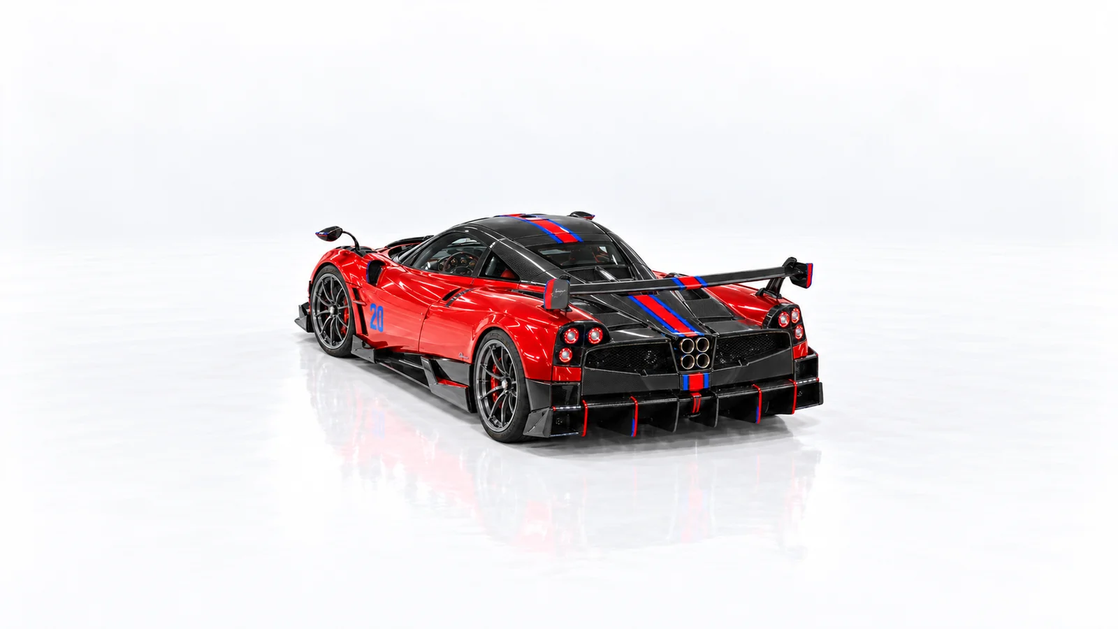 Closed rear three-quarter view of the red Huayra BC, showing its wing and four exhaust pipes