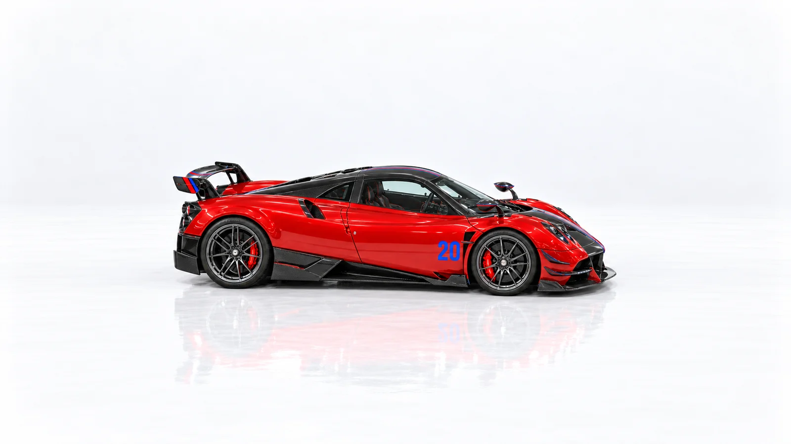 Right side profile of the red Huayra BC in the white studio
