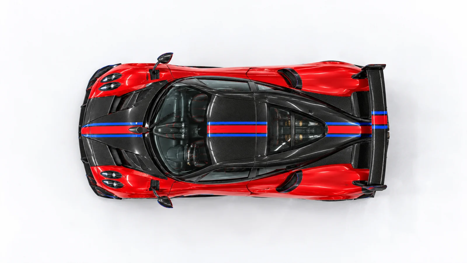 Overhead view of the red Huayra BC with exposed carbon roof and longitudinal racing stripes