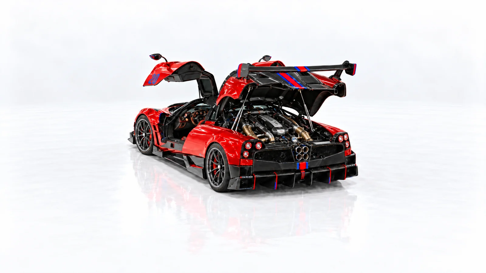 Red Huayra BC with doors and rear engine cover open, revealing the engine bay